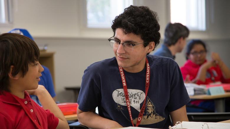 A student teacher works together with an elementary-aged student.